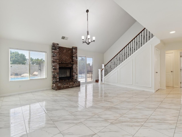 2091 E Cromwell Ave, Fresno, CA 93720 - unfurnished living room with a chandelier, high vaulted ceiling, light marble finish flooring, a brick fireplace, and stairs