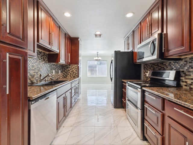 2091 E Cromwell Ave, Fresno, CA 93720 - kitchen featuring stainless steel appliances, light marble finish flooring, tasteful backsplash, recessed lighting, and reddish brown cabinets