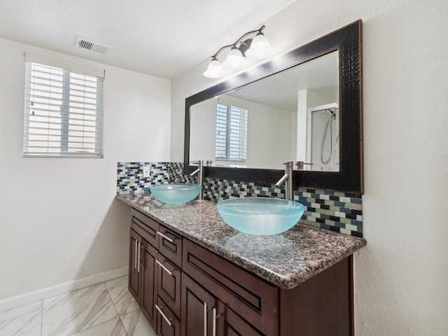 2091 E Cromwell Ave, Fresno, CA 93720 - bathroom with decorative backsplash, double vanity, and marble finish floors