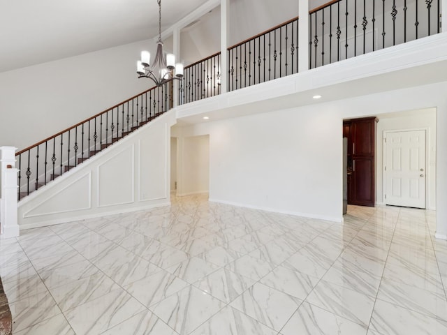 2091 E Cromwell Ave, Fresno, CA 93720 - unfurnished living room featuring high vaulted ceiling, light marble finish flooring, a chandelier, and stairway