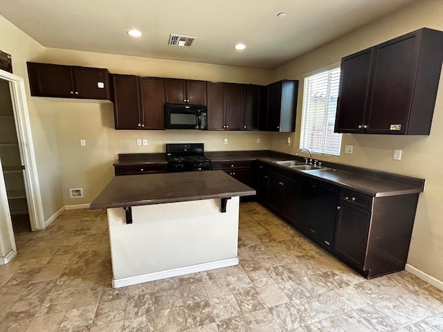 5795 E Beck Ave, Fresno, CA 93727 - kitchen with black appliances, dark countertops, a sink, baseboards, and a kitchen bar