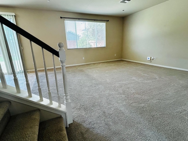 5795 E Beck Ave, Fresno, CA 93727 - unfurnished living room featuring carpet, baseboards, and stairway