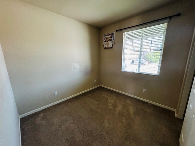5795 E Beck Ave, Fresno, CA 93727 - empty room featuring dark colored carpet and baseboards
