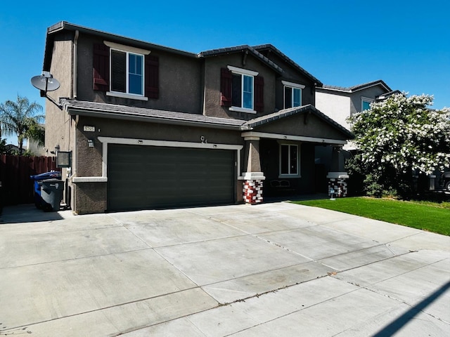 5795 E Beck Ave, Fresno, CA 93727 - view of front facade featuring an attached garage, stucco siding, driveway, and a porch