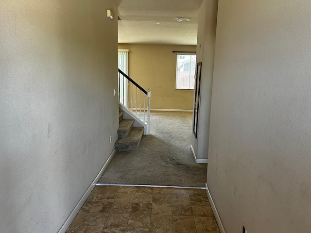 5795 E Beck Ave, Fresno, CA 93727 - corridor featuring baseboards, stairway, and stone finish flooring