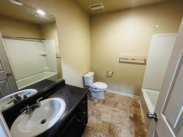 5795 E Beck Ave, Fresno, CA 93727 - full bath with vanity, toilet, shower / bath combination, and stone finish floors