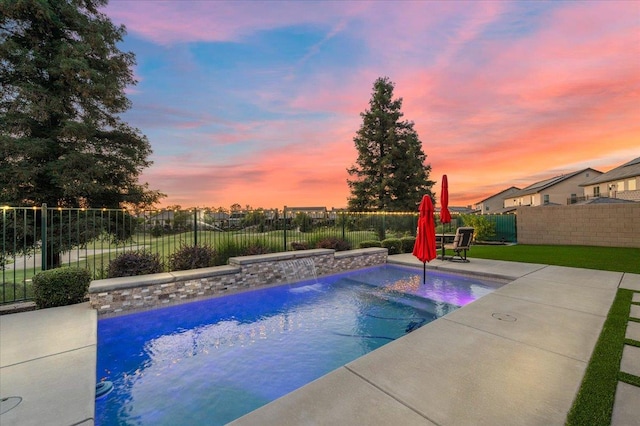 11753 N Turf Dr, Fresno, CA 93730 - pool at dusk featuring a fenced backyard and a patio area