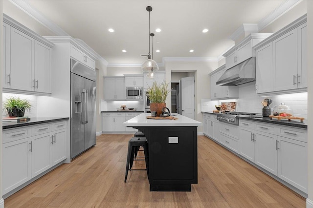 11753 N Turf Dr, Fresno, CA 93730 - kitchen featuring built in appliances, under cabinet range hood, a center island, crown molding, and tasteful backsplash