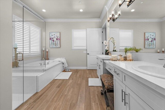 11753 N Turf Dr, Fresno, CA 93730 - full bath with crown molding, a garden tub, vanity, wood finished floors, and plenty of natural light