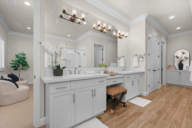 11753 N Turf Dr, Fresno, CA 93730 - full bath featuring two vanities, a stall shower, recessed lighting, baseboards, and wood finished floors