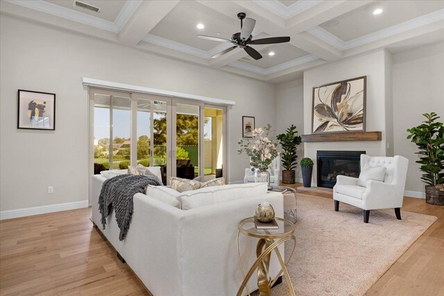 11753 N Turf Dr, Fresno, CA 93730 - living room featuring beamed ceiling, light wood-style floors, a glass covered fireplace, coffered ceiling, and a ceiling fan