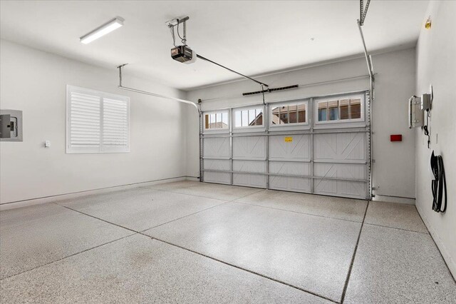 11753 N Turf Dr, Fresno, CA 93730 - garage with electric panel, a garage door opener, and baseboards