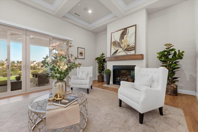 11753 N Turf Dr, Fresno, CA 93730 - living area featuring beamed ceiling, coffered ceiling, a glass covered fireplace, ornamental molding, and baseboards