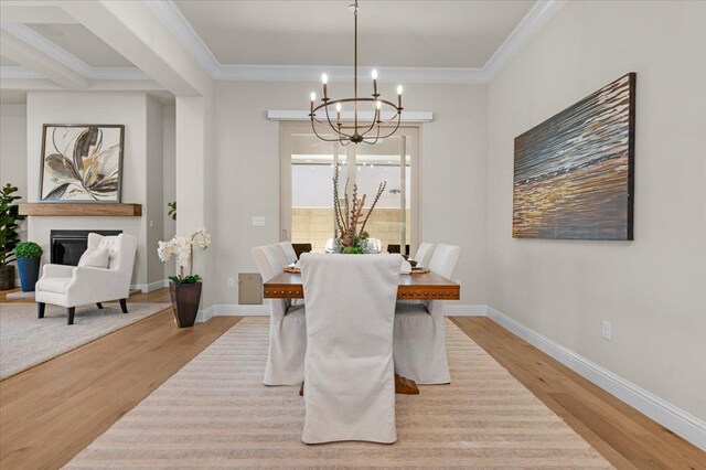 11753 N Turf Dr, Fresno, CA 93730 - dining room featuring a chandelier, wood finished floors, crown molding, and baseboards