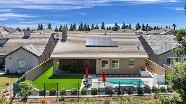 11753 N Turf Dr, Fresno, CA 93730 - rear view of house with a patio, solar panels, stucco siding, and a residential view
