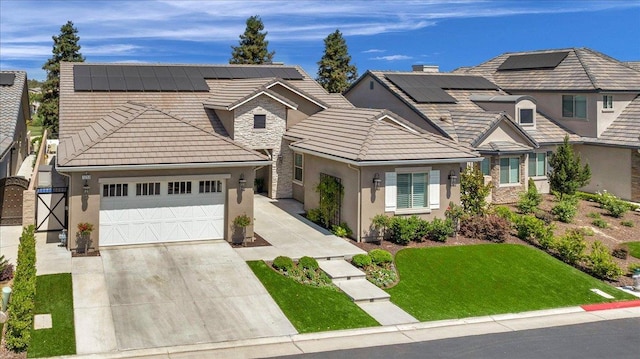 11753 N Turf Dr, Fresno, CA 93730 - view of front of property featuring stucco siding, an attached garage, driveway, and roof mounted solar panels