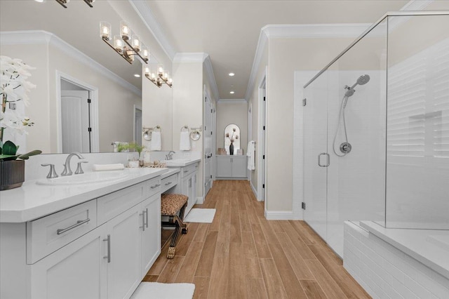 11753 N Turf Dr, Fresno, CA 93730 - bathroom with double vanity, a stall shower, a chandelier, wood finished floors, and ornamental molding