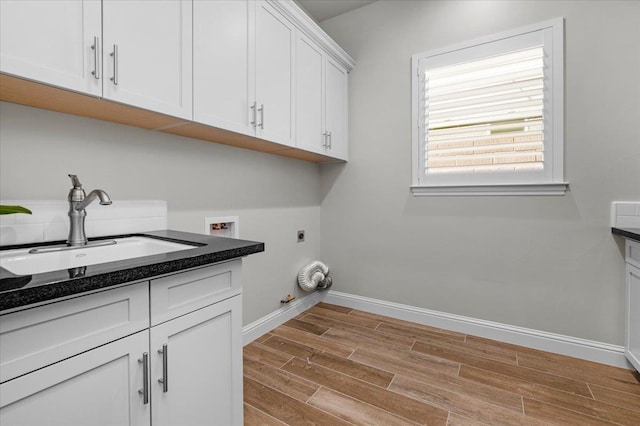 11753 N Turf Dr, Fresno, CA 93730 - washroom with wood tiled floors, cabinet space, hookup for a washing machine, baseboards, and electric dryer hookup