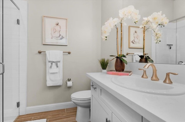 11753 N Turf Dr, Fresno, CA 93730 - bathroom with vanity, a shower stall, wood finished floors, toilet, and baseboards
