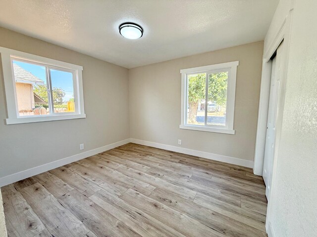 1310 Fresno St, Madera, CA 93638 - unfurnished bedroom featuring light wood finished floors, baseboards, and a closet