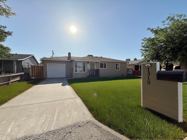 1310 Fresno St, Madera, CA 93638 - ranch-style house featuring concrete driveway, an attached garage, and stucco siding