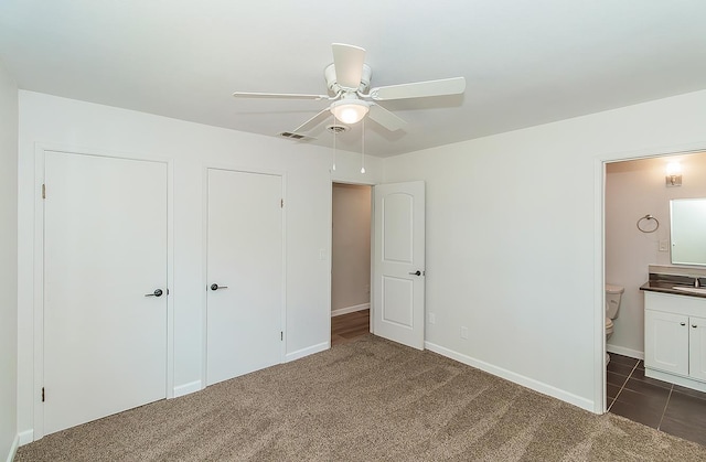 709 Keith St, Lemoore, CA 93245 - unfurnished bedroom featuring dark colored carpet, ensuite bathroom, and ceiling fan