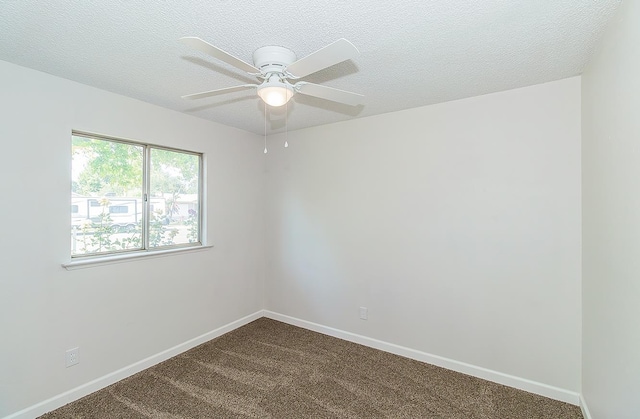 709 Keith St, Lemoore, CA 93245 - spare room featuring dark carpet, ceiling fan, and a textured ceiling