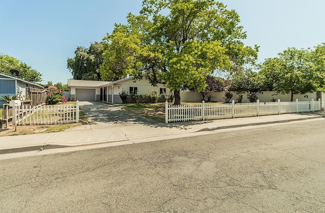 709 Keith St, Lemoore, CA 93245 - view of front of house with a garage, driveway, and a fenced front yard