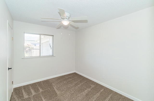 709 Keith St, Lemoore, CA 93245 - spare room with dark carpet, ceiling fan, and a textured ceiling