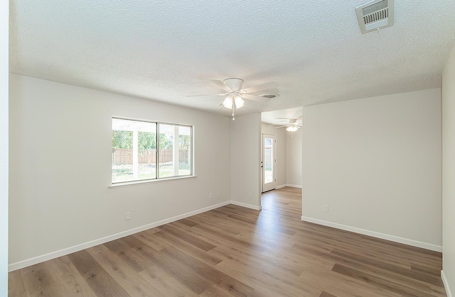709 Keith St, Lemoore, CA 93245 - empty room featuring wood finished floors, a ceiling fan, and a textured ceiling