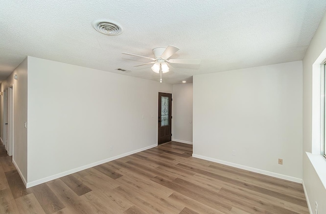 709 Keith St, Lemoore, CA 93245 - unfurnished room with light wood-style flooring, ceiling fan, and a textured ceiling