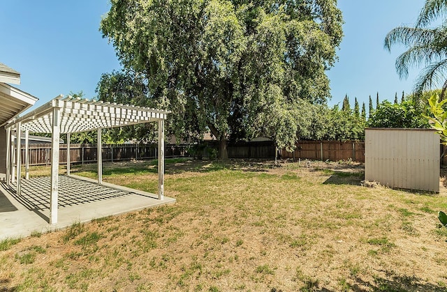 709 Keith St, Lemoore, CA 93245 - fenced backyard featuring a pergola, a patio area, and a storage shed