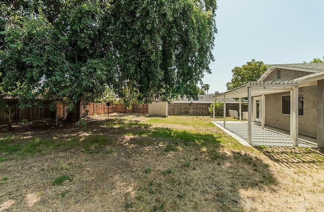 709 Keith St, Lemoore, CA 93245 - fenced backyard featuring a shed, a pergola, and a patio area