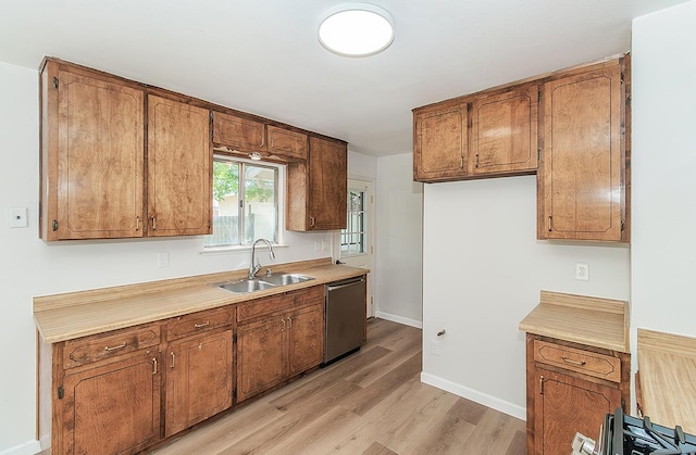 709 Keith St, Lemoore, CA 93245 - kitchen featuring dishwasher, brown cabinets, and light wood finished floors