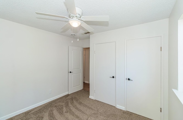 709 Keith St, Lemoore, CA 93245 - unfurnished bedroom with carpet floors, a textured ceiling, and ceiling fan