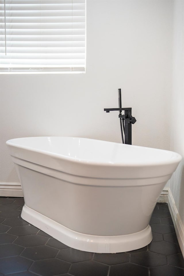 2048 W Sierra Ave, Fresno, CA 93711 - bathroom with a freestanding tub, baseboards, and tile patterned floors