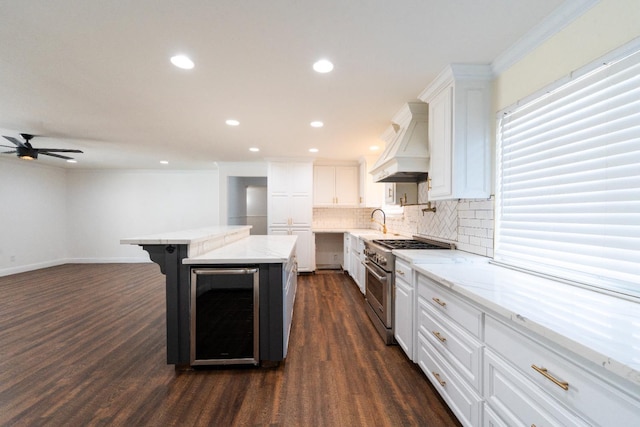 2048 W Sierra Ave, Fresno, CA 93711 - kitchen featuring high end range, custom exhaust hood, beverage cooler, tasteful backsplash, and white cabinets
