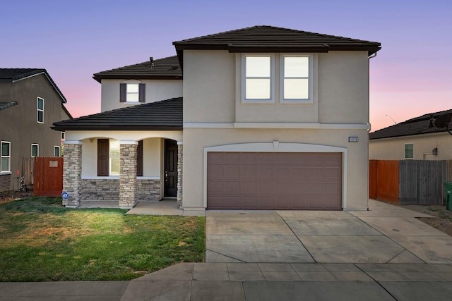 1276 Sauret St, Madera, CA 93638 - traditional-style home featuring a garage, covered porch, driveway, stucco siding, and a tile roof