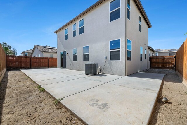 1276 Sauret St, Madera, CA 93638 - back of house with central AC unit, a patio, a fenced backyard, and stucco siding