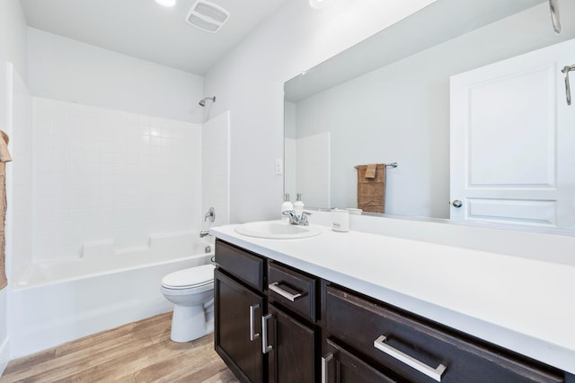 1276 Sauret St, Madera, CA 93638 - full bath with wood finished floors, toilet, vanity, and bathtub / shower combination