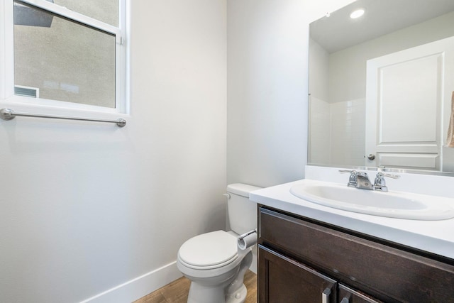 1276 Sauret St, Madera, CA 93638 - bathroom with wood finished floors, toilet, vanity, and baseboards