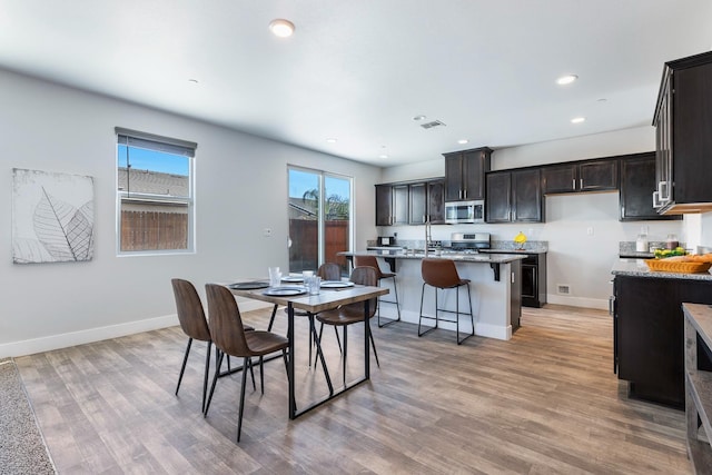 1276 Sauret St, Madera, CA 93638 - dining space with light wood-style floors, baseboards, and recessed lighting