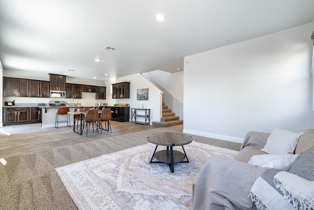 1276 Sauret St, Madera, CA 93638 - living room with stairs, baseboards, recessed lighting, and light wood-style flooring