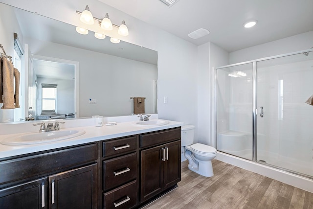 1276 Sauret St, Madera, CA 93638 - full bath featuring wood finished floors, double vanity, a shower stall, and toilet