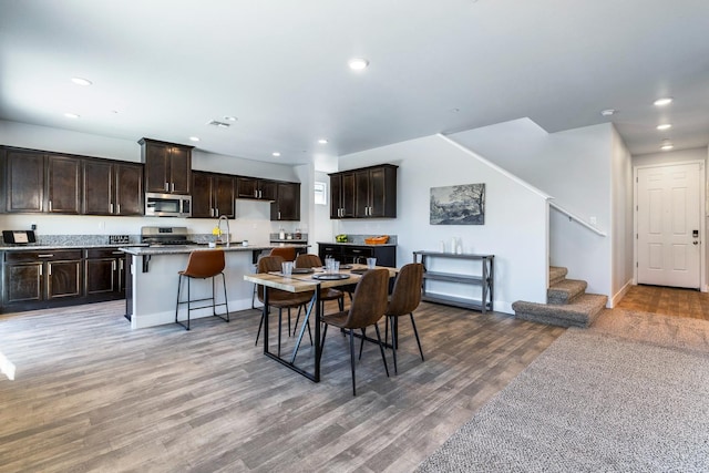 1276 Sauret St, Madera, CA 93638 - dining area with recessed lighting, stairway, light wood-type flooring, and baseboards