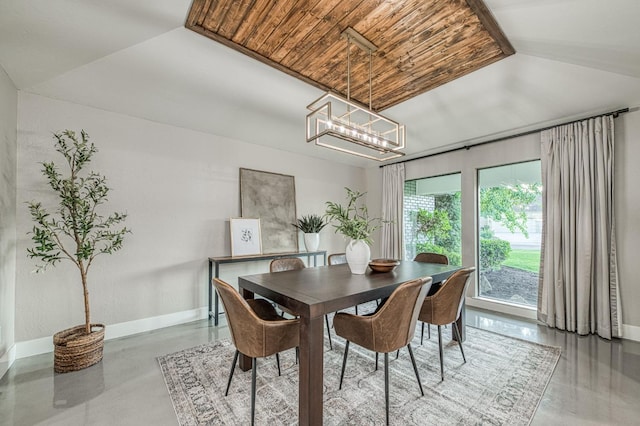 3841 W Alluvial Ave, Fresno, CA 93711 - dining space featuring baseboards, concrete flooring, wooden ceiling, and a chandelier