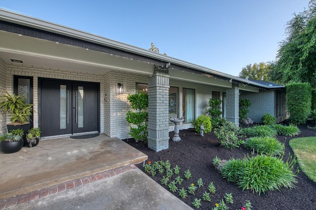 3841 W Alluvial Ave, Fresno, CA 93711 - view of exterior entry featuring brick siding and a porch