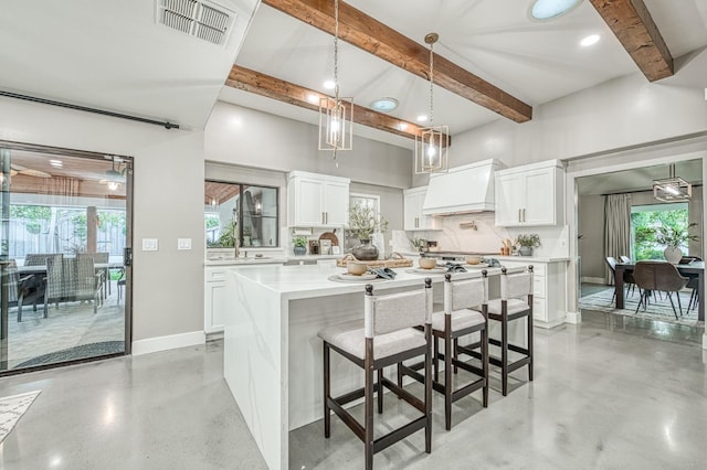 3841 W Alluvial Ave, Fresno, CA 93711 - kitchen featuring custom exhaust hood, beamed ceiling, decorative backsplash, light countertops, and white cabinets