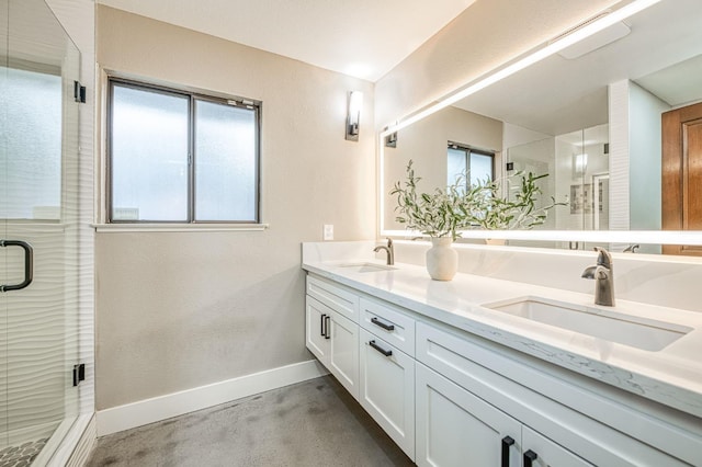 3841 W Alluvial Ave, Fresno, CA 93711 - bathroom featuring double vanity, a shower stall, baseboards, and concrete floors