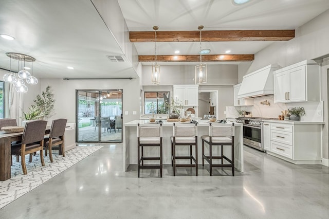 3841 W Alluvial Ave, Fresno, CA 93711 - kitchen with high end range, custom exhaust hood, a breakfast bar, white cabinets, and beam ceiling